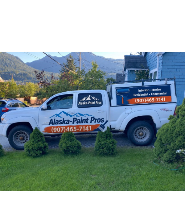 Professional painting company service truck parked near a home